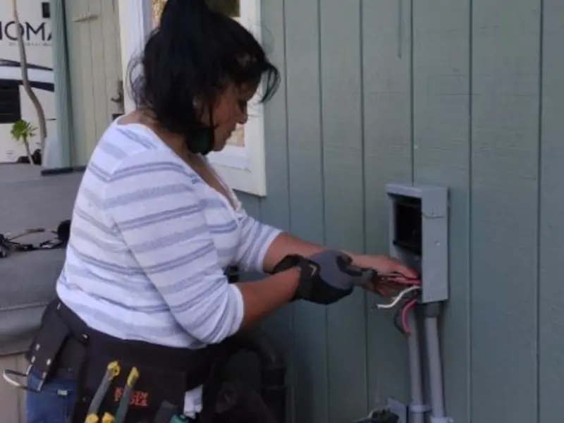 Licensed electrician wiring an exterior subpanel in Park City